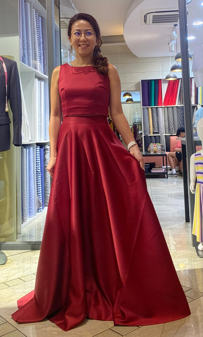 Woman wearing a custom red evening dress designed and tailored by Vy in New York City