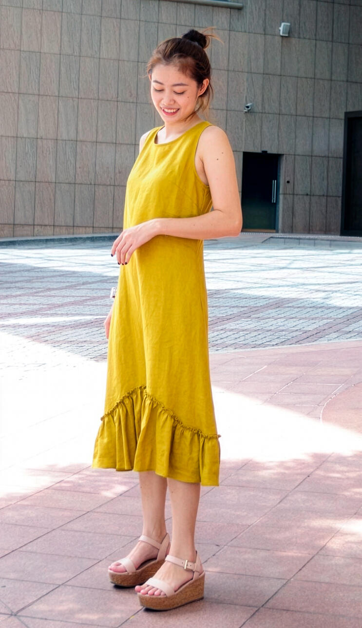 Woman wearing a custom yellow dress designed and tailored by Vy in New York City